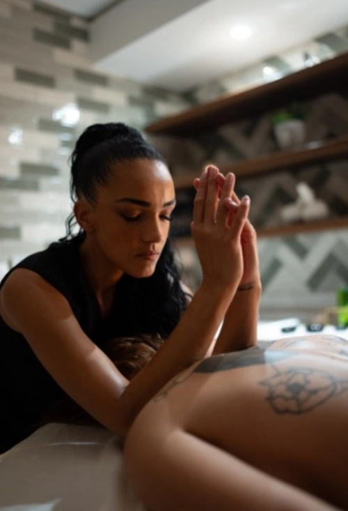 Holistic massage, pushing on shoulders.